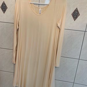 Long sleeve, light weight, apricot dress. Knee length. Never worn. Has tags.